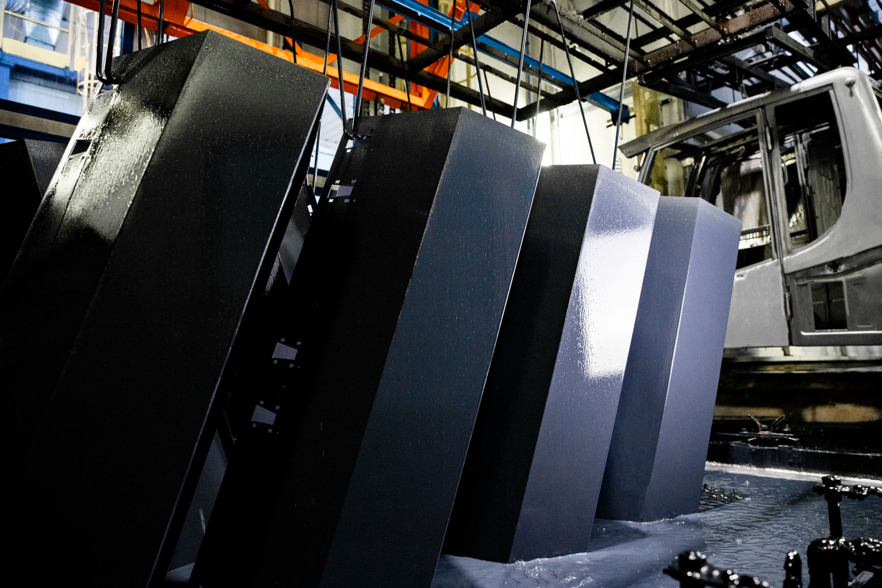 Agricultural machinery parts emerging from the e-coating tank