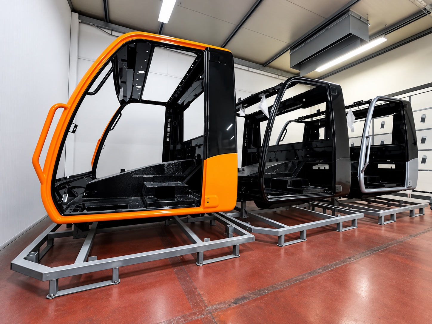 Liquid-coated machine cabs awaiting the drying and curing stage
