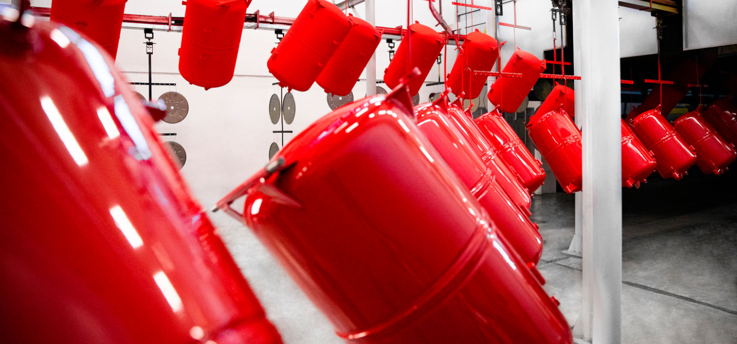 Red powder-coated components during oven curing